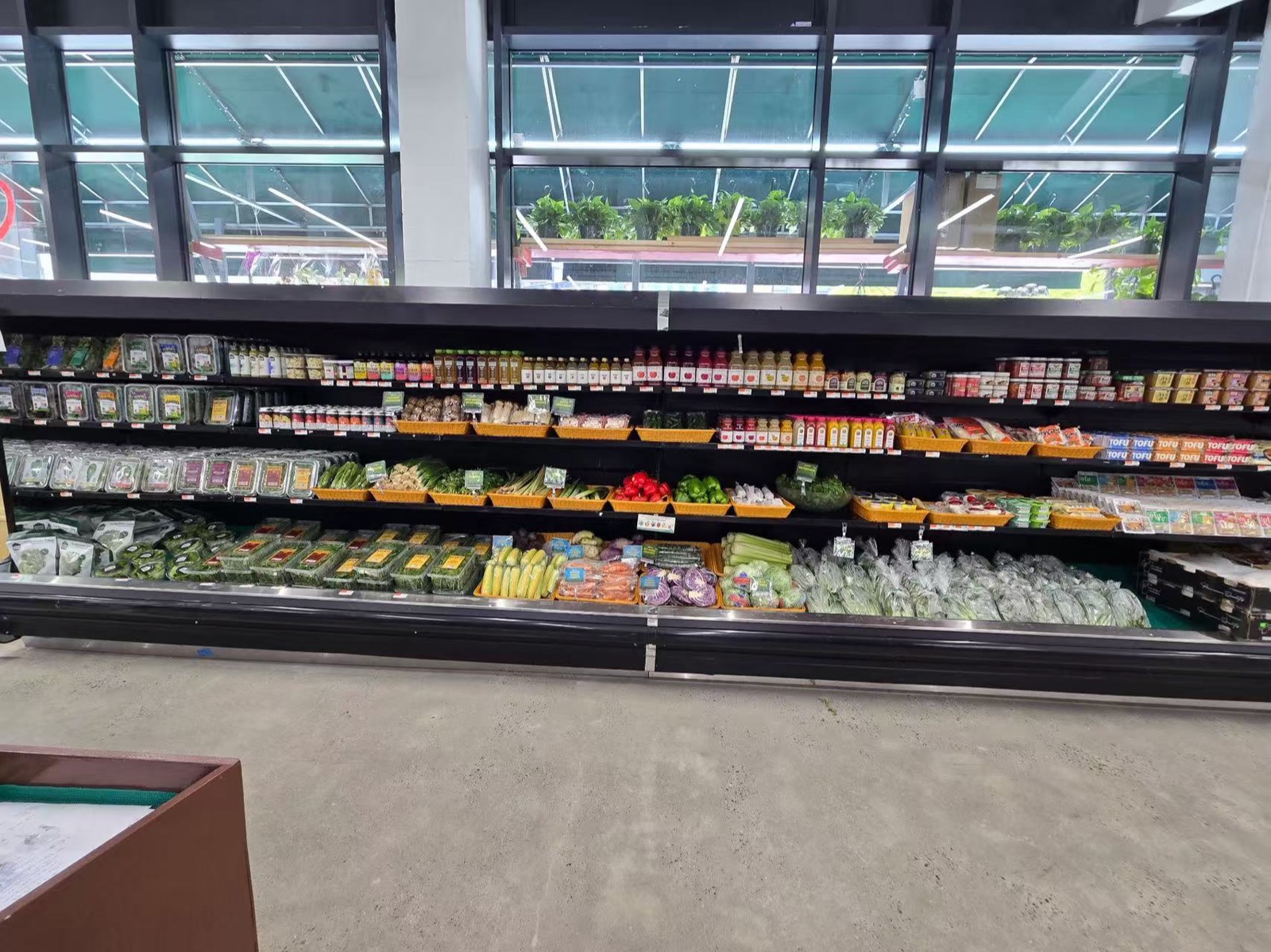 Fresh vegetables, tofu, herbs, and prepared items displayed in SMART LIC